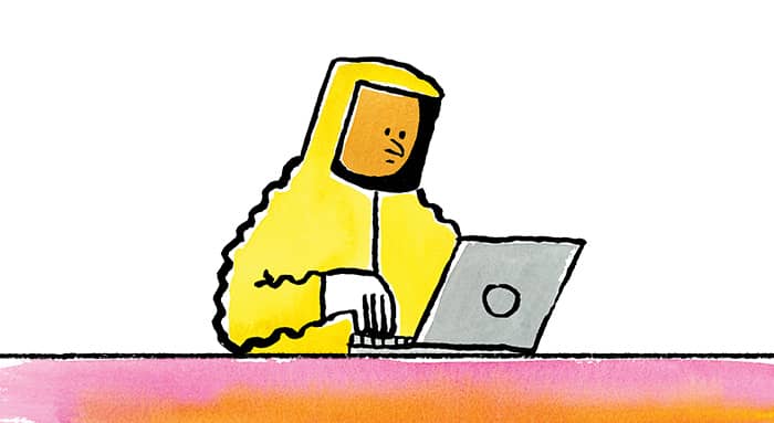 A person in a hazmat suit on the computer