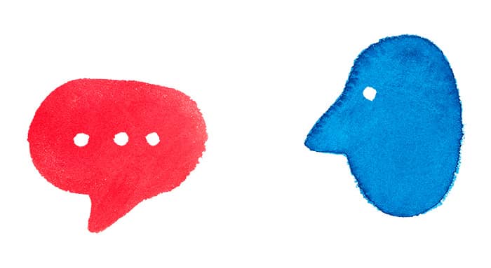 a red message bubble with a blue face next to it